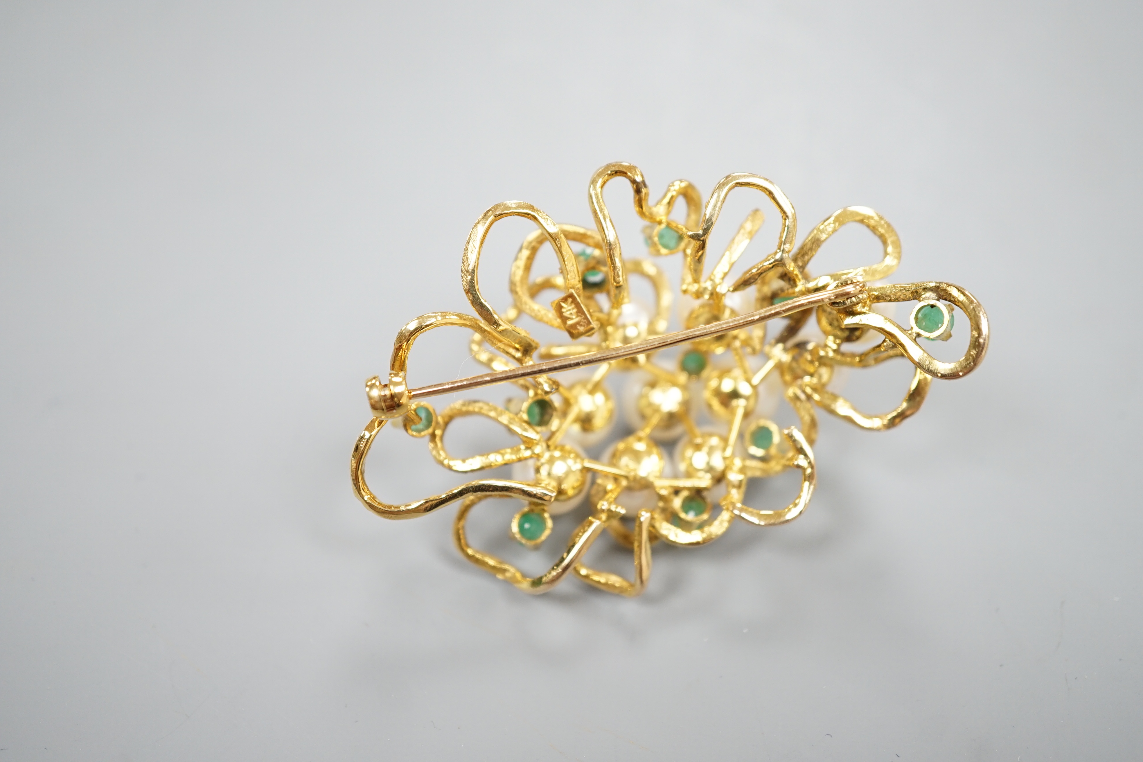 A modern 14k yellow metal, cultured pearl and emerald cluster set brooch, 54mm, gross weight 18.9 grams.